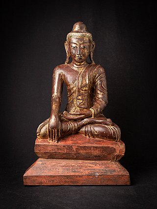 Burmese wooden Buddha statue seated in bhumisparsha mudra on red base, full-front view