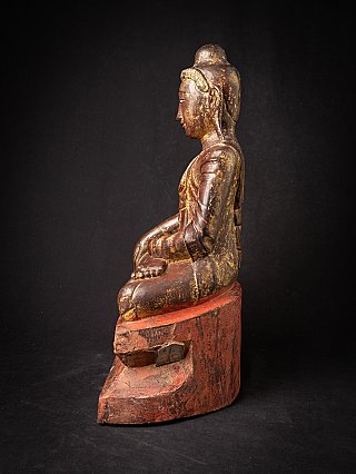 Burmese wooden Buddha statue seated, left side profile with red plinth