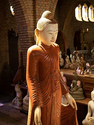 Upper-body detail of a Burmese marble Buddha statue with face and robe folds