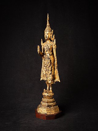 Bronze Buddha statue from Thailand, three-quarter view showing the raised right hand