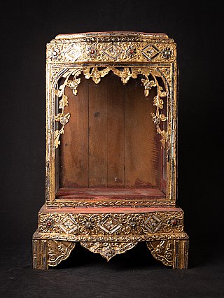 Antique wooden Burmese Buddha temple, front view with open niche and gilt decoration