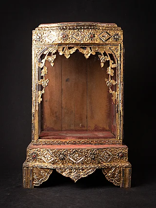 Antique wooden Burmese Buddha temple, front view with open niche and gilt decoration