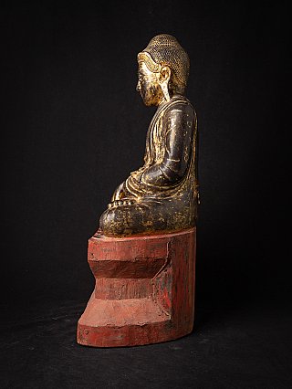 Antique Burmese wooden Buddha statue, left side profile in seated posture