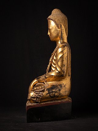 Burmese lacquerware Buddha statue seated on a high base, left side view