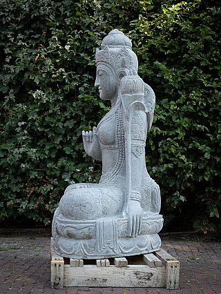 Dewi Tara stone statue, side profile view showing the lowered hand on the knee