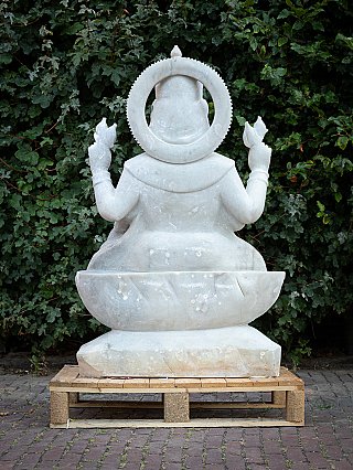 Marble Lakshmi statue seated rear view showing four arms and large circular halo