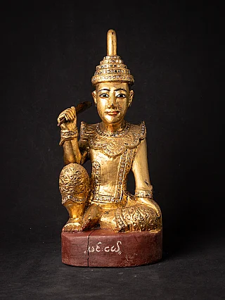 Burmese Nat statue in wood, seated, with gilded surface and red base, front view