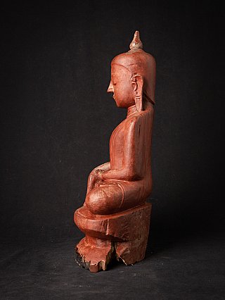Wooden Burmese Buddha statue, left side profile view with elongated earlobe
