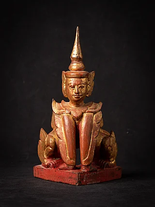 Burmese Nat statue in wood on red base, full-front view with tall pointed headdress
