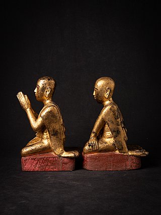 Paar hölzerner Mönchsfiguren (Myanmar), sitzend, Seitenansicht mit Gebetshänden bei einer Figur