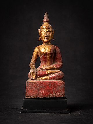 Thai wooden Buddha statue seated in bhumisparsha mudra, full front view on black base