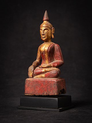 Wooden Thai Buddha statue with red and gold finish, three-quarter left view