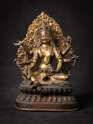 Gilt-bronze Vasudhara statue from Nepal, seated front view with multiple arms and halo