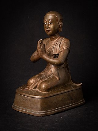 Burmese bronze monk statue with hands in prayer, three-quarter view