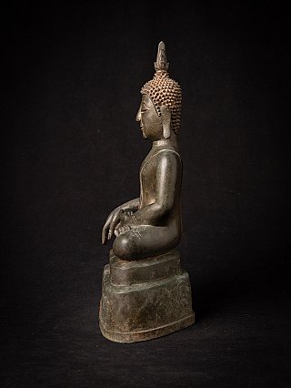 Thai bronze Buddha statue seated on base, side profile view