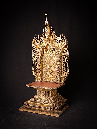 Wooden Buddha throne, Mandalay period, three-quarter left view showing carved sides