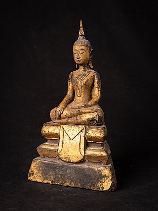 Wooden Thai Lanna Buddha statue, three-quarter view showing the stepped base