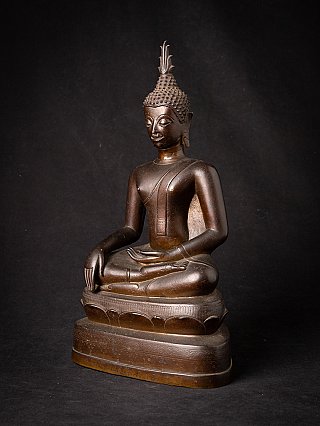 Thai bronze Buddha statue on pedestal, three-quarter view showing bhumisparsha mudra