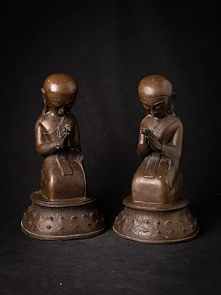 Pair of Burmese bronze monk statues seated with hands in namaskara mudra, front view