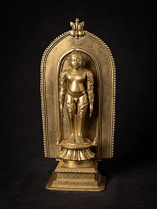 Jain shrine from India with standing figure on lotus base, full front in arched niche