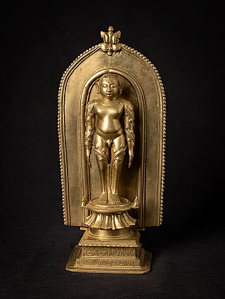 Jain shrine from India with standing figure on lotus base, full front in arched niche