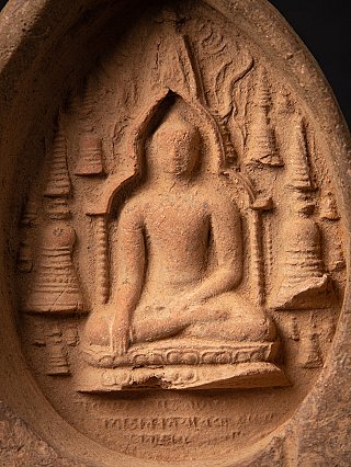 Seated Buddha relief with background motifs, close-up on the tablet’s central scene