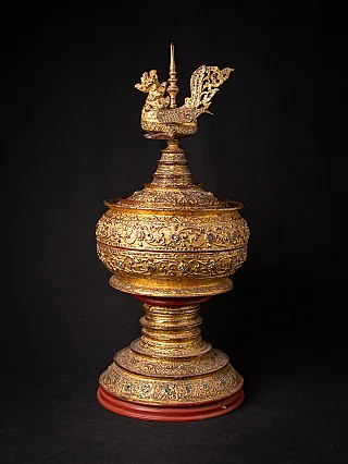 Gilded Burmese lacquerware offering vessel, three-quarter view with bird finial