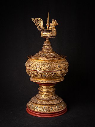 Antique gilded Burmese offering vessel, three-quarter view showing openwork bird finial
