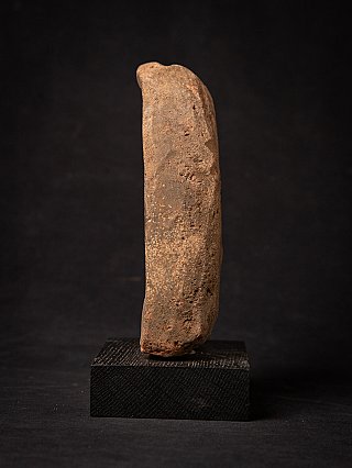 Side profile of the Pagan votive tablet showing its thickness and worn surface