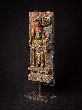 Kartikeya statue carved in wood on a panel, three-quarter view showing depth