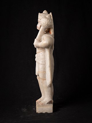 Marble Hanuman statue in side profile, showing the mace and the tail