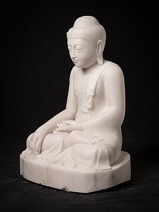 Buddha statue from Myanmar in white marble, seated, three-quarter view from left
