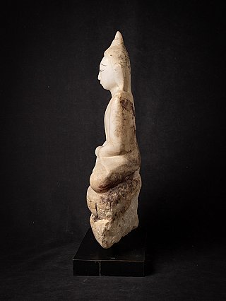 Burmese marble Buddha statue seated, side profile with rough back of the base visible