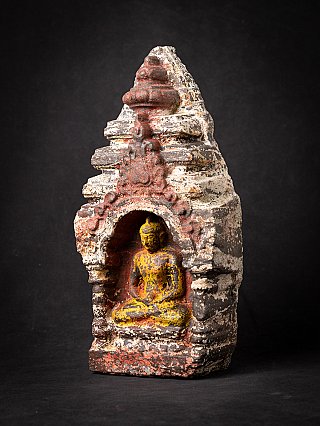 Thai marble Buddha statue seated in dhyana mudra in niche, three-quarter left view