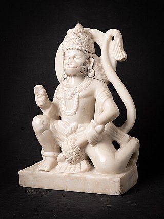 Marble Hanuman statue, three-quarter view showing the tail and seated posture on rectangular base