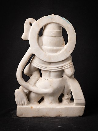 Rear view of the marble Hanuman statue showing the circular tail loop and base