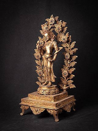 Bronze Lokeshwor statue from Nepal with floral backplate, three-quarter view