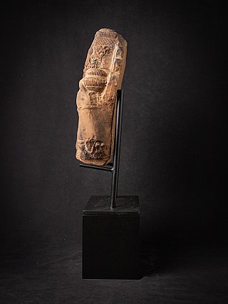 Side profile of the Vishnu bust showing carved arm and relief