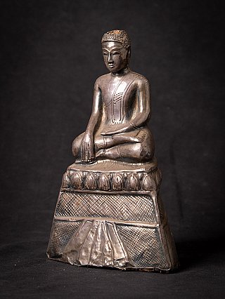 Thai Buddha statue seated on a stepped base, three-quarter left view