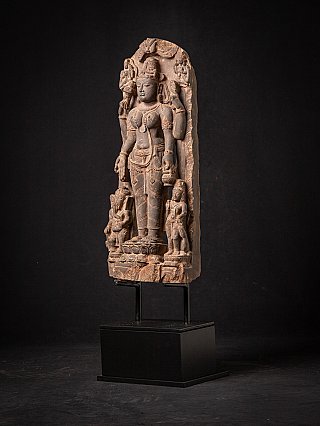 Saraswati statue relief with side figures, three-quarter left view on stand