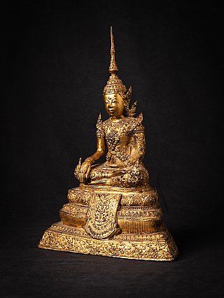 Bronze Buddha statue from Thailand in three-quarter left view, tall crown and ornate base