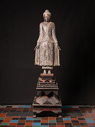 Burmese wooden Buddha statue on tall tiered base, full-front view