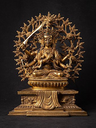 Manjushri statue in bronze from Nepal with sword and foliate halo, full-front view