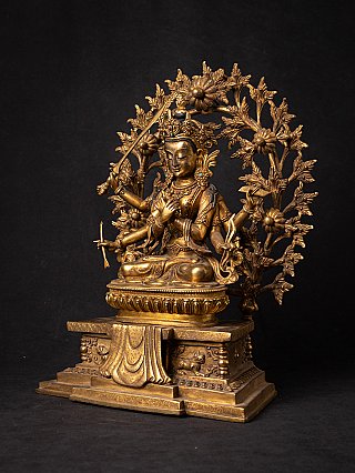Bronze Manjushri statue from Nepal holding a sword, three-quarter-left view