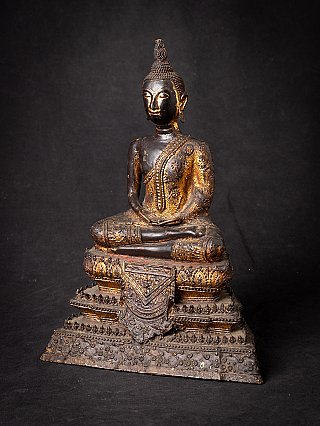 Bronze Buddha statue from Thailand with worn gilded details, three-quarter right view