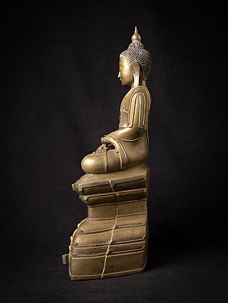 Burmese bronze Buddha statue seated on stepped pedestal, left side profile