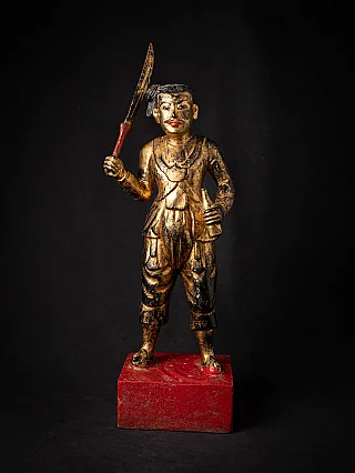 Burmese Nat statue in wood on a red base, standing with sword and bottle, full front view