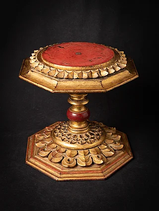 Gilded wooden Buddha stand from Burma with red top and lotus rim, three-quarter view