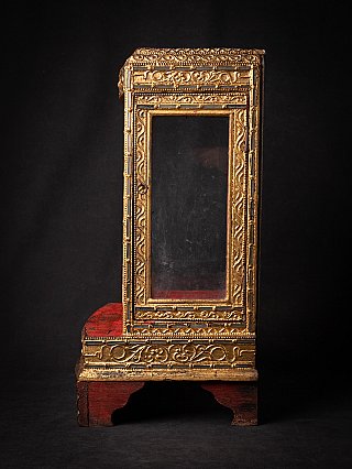 Burmese wooden temple shrine, side view showing the glass panel door and gilded frame