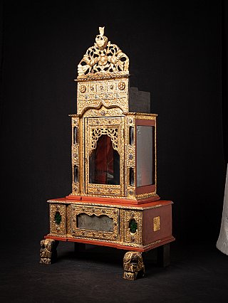 Burmese wooden Buddha temple shrine, three-quarter view showing gilded front and red side